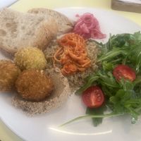 Vegan breakfast included toasted bread, whipped tofu spread, pickled onions, falafels, quinoa with enoki mushrooms and side salad  at Kultura Diktuet in Astana