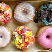 Flavor variety. Top row - ‘Saturday Morning Cartoons', Lavender, Cookie Monster. Bottom row - Hibiscus, ‘Saturday morning cartoons’, Rose   at Monster Baby Donuts - Pop up in Columbus