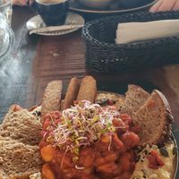 Front hummus and baked beans with tempeh. Back scrambled tofu wrap with two sauces. Both were very good. at Vega in Wroclaw