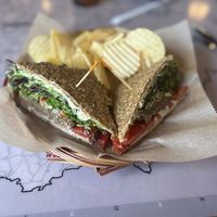 Athena’s Gift- Raw, gluten-free vegan sausage topped with cashew cheeze spread, spring mix, olive salad, and tomatoes. Served with chips and a pickle spear.   at European Street in Jacksonville