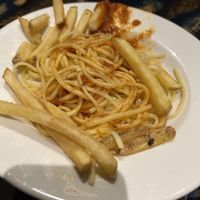 Kids spaghetti meat balls (obvs ask for no meat balls to make it vegan) sauce came in separate bowl and a few chips of our plates   at Disneyland - Rainforest Cafe    in Chessy