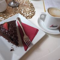 Chocolate cake and oat milk cappuccino at Barbarella Cafe in Aachen