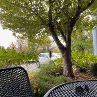 Three shaded tables just outside for patio dining at Firehouse Deli in Gaithersburg