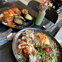 Mezze platter with potato, eggplant, carrot, okra, chickpea ragout, date cream & chili chutney | Qabeli rice with eggplant in tomato & vegan yoghurt mint sauce with salad  at memán restaurant in Hamburg