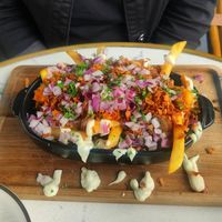 Loaded fries with sausage and sauce at OhMA Gent in Ghent