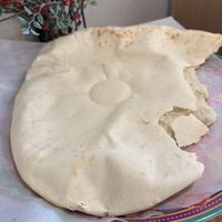 Huge, hot, smoking pita with spices in oil    at Nicholas Restaurant in Gresham