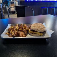 Tofu bacon breakfast sandwich on an English muffin. With potatoes at Brunch Box in Springfield