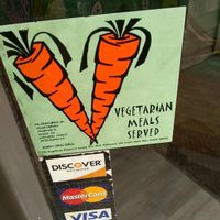 Sticker on door "Vegetarian meals served"  at Tricky Fish in Charleston