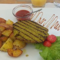 Polenta Peas burger with baked potatoes at Zam Tachji in Alagna Valsesia