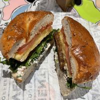 Rosemary salt bagel, arugula, tomato, veggie tofu spread, just egg & tempeh baconn  at Pavement Coffeehouse - Newbury in Boston
