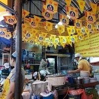 Veggie food stall with yellow flags  at Vegan Thai Food Stalls in Bangkok
