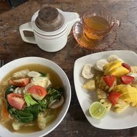 Noodle soup with vegetables, fruit plate and tamarind tea  at Water Castle Cafe in Yogyakarta