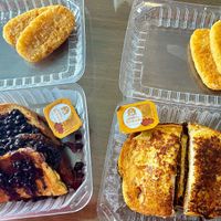 Blueberry Stuffed French Toast (left) with Hash Brown Patties (top) & Plant-based Sausage Egg & Cheese French Toast Sandwich (right) with Hash Brown Patties (top) at Lilis Vegan Breakfast - Cloud Kitchen   in Lawndale