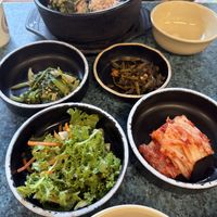 Various toppings from morning glory, seaweed, and kimchi   at YooJung SikDang - 유정식당 in Seoul