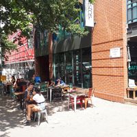 Outdoor sitting area under a tree at Scullin Sweet Bones in Scullin
