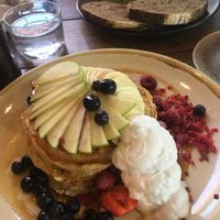 Blueberry pancakes, syrup, fruit, coconut cream   at Sweet Bones Bakery Cafe in Scullin