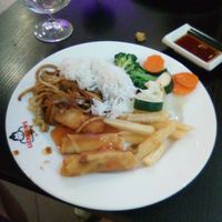 Spring rolls, fries, noodles, rice, and vegetables at Luckiefun's - Redi in Helsinki
