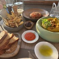Sourdough, olives, riganada, chickpea stew, fresh potatoes (chips…!)  at Oia Gefsis in Oia