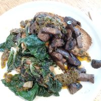 Greens and mushrooms on gluten free toast, just missing the coconut yogurt. at Postal Service in Auckland
