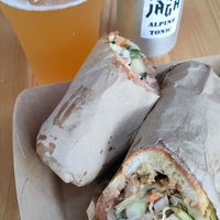 Vegan sandwich with vegan gyros meat. Draft beer from a local brewery. Local made herbal tonic at Divja Jaga in Bohinjsko Jezero