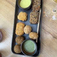 ‘Mix hug’: Olives stuffed with minced soy, ‘Mozzarelline’ - fermented cashew with quinoa breading, Spicy falafel, Tofish - marinated tofu with nori seaweed.  at Cagiada Milano in Milan