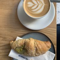 Pistachio cornetto and cappuccino w\ oat milk   at Grey Kaffee in Vienna