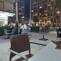 Outdoor seating area by the promenade at Heladeria Antiu Xixona in Cullera