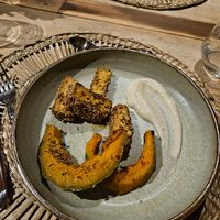 Chickpeas tempeh, pumpkin, sauce at il Brucaliffo Cucina in Castiglione Dorcia