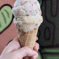 Plant Based Birthday Cake on top of Snickers in a waffle cone. at Plant Love Ice Cream  in Gulfport