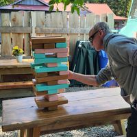 Enjoying giant jenga and sake cocktails for happy hour in the cute patio area at Hide N' Seek in Sooke