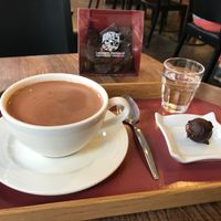 Big hot chocolate with a piece and water at Laurent Gerbaud Chocolatier in Brussels