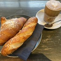 croissant, pretzel roll and flat white  at A Little Lost in Munich