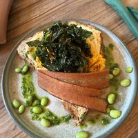 Tofu on seeded toast with hummus and crispy kale   at Plant. Eat. Licious in Bath