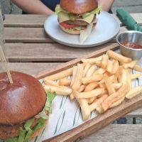 Bugerlicious burger and fake chicken burger with chips and spicy chili sauce at Plant. Eat. Licious in Bath