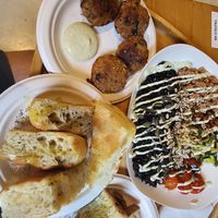 Foccacia, pain au levain, balls with lentils and potatoes, black rice with vegan tuna, chickpeas, sunflower seeds, grilled tomatoes and salad at GIARDÍ  in Milan