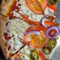 Pizza with vegan cheese at The Pitstop at Kintail in Kyle Of Lochalsh