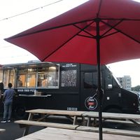 View of the pizza truck from seating area  at Josies Pizza Bar in Glen Cove