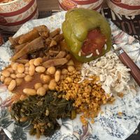 All plant-based meal featuring a potato stew, rice-stuffed bell pepper, spinach, beans and chickpeas, and grains and rice.  at Lezzet Lokantasi in Mugla