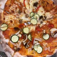 Pizza - half vegan, half with cheese  at Delirium Pizza & Arte  in Quito