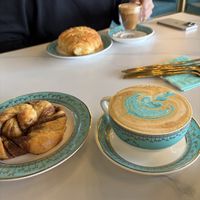 Swedish cinnamon roll (front) Pistachio cream croissant with cortado (back)  at Unicorniverse Bakery & Cafe in Round Rock