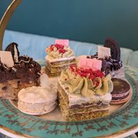 Top tier of afternoon tea, 2 cakes and 2 macaroons at Unicorniverse Bakery & Cafe in Round Rock