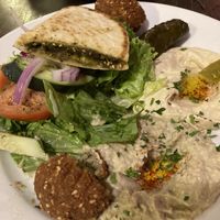 The veggie platter with hummus, baba ghannuj, za’tar pita, falafel, rolled grape leaves, and salad .  at Zayna Mediterranean in Tucson