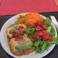 Vegan steak with vegan cheese, quinoa and salad at Vegetariana in Buenos Aires