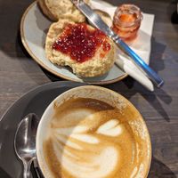 Oatmilk latte and delicious vegan scone with jam 😋 I love when scones are not sweet ❤️ at Tanifiki in Edinburgh