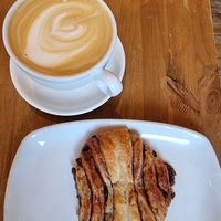 Oatmilk latte and chocolate-cinnamon bun at Ecocafe in Budapest