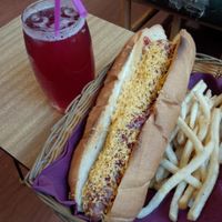 Red Hot Dawg with tomato sauce, vegan cheese, and fries on the side. at Two-Bit Villains in Adelaide