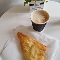 Oatmilk latte and spinach pastry at Greek Artisan Pastries in Edinburgh