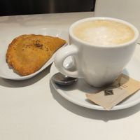 Vegan pastry (empanada) with plant-based coffee. at Paquita Degustació in Tarragona