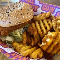 Vegan Buffalo chicken burger with waffle fries  at The Saucy Cow in Cork