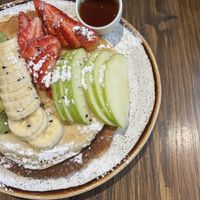 Vegan pancakes with Seasonal fruit, sesame seeds and maple syrup  at Kaju in Coimbra